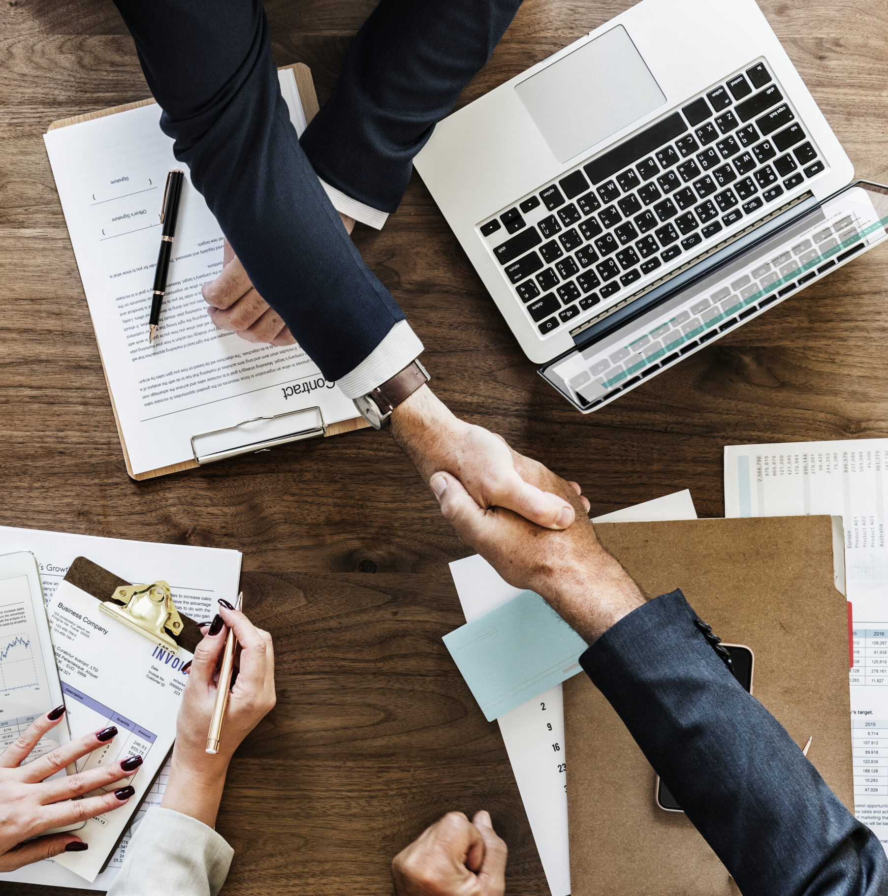 Business people shaking hands together
