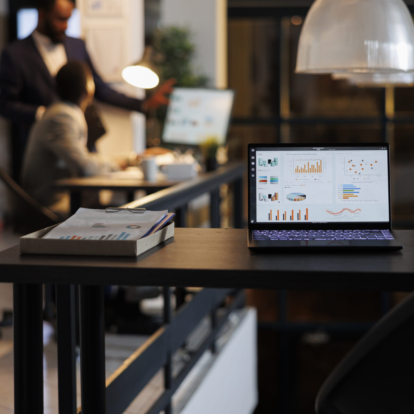 Laptop computer with financial graphs on screen